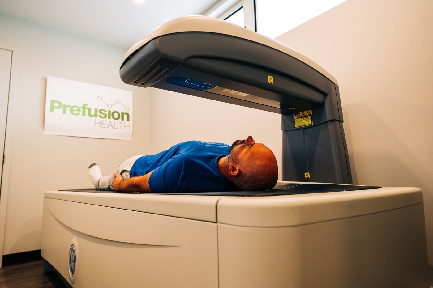 Client on the DEXA scanner at Prefusion Health